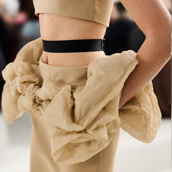 Max Mara Spring/Summer 2026 Fashion Show - Detail shot showing waistline of a beige skirt with ruffles and black belt.
